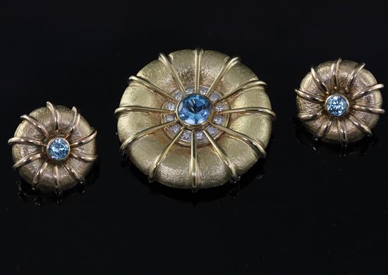 A 9ct gold, blue zircon and diamond set circular pendant brooch, and a similar pair of 9ct gold and blue zircon and earrings